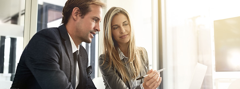 A man and a woman discussing charts