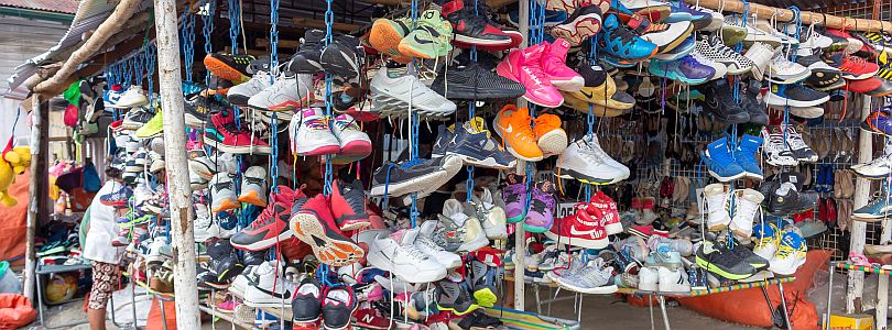 many shoes at a market stall