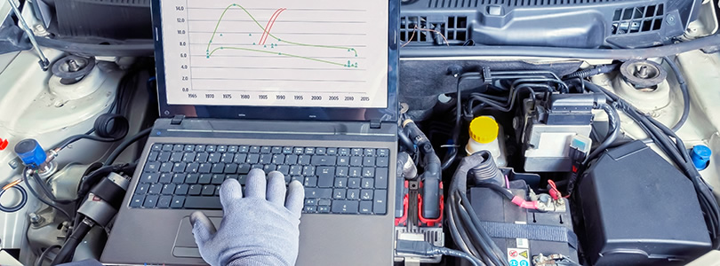 Open engine bonnet with hand and notebook