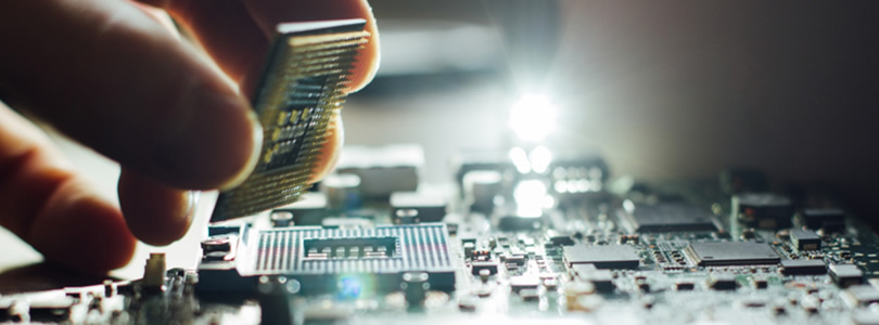 Hand with computer chip and motherboard