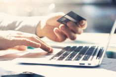 Hand, notebook keyboard and credit card